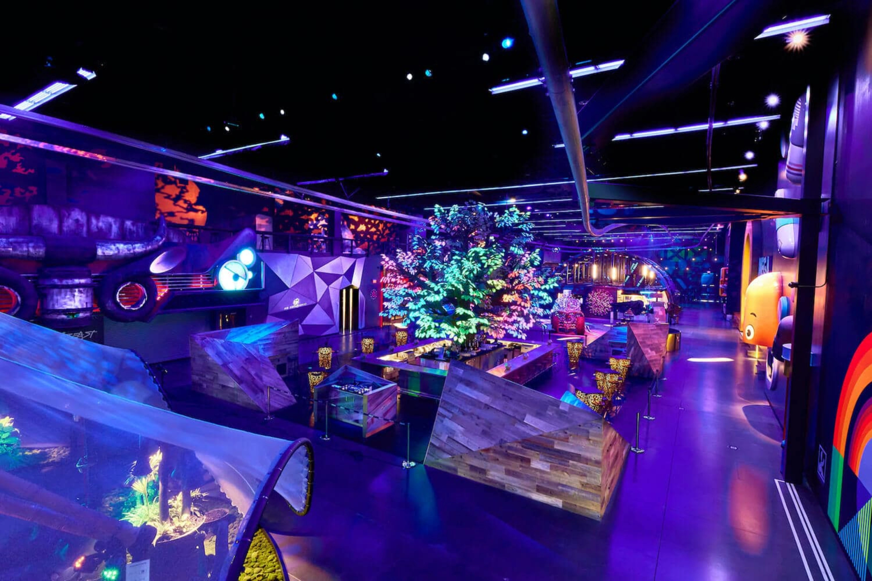 Interior of Area15 Las Vegas showcasing immersive art installations, vibrant lighting, interactive exhibits, and futuristic design elements.