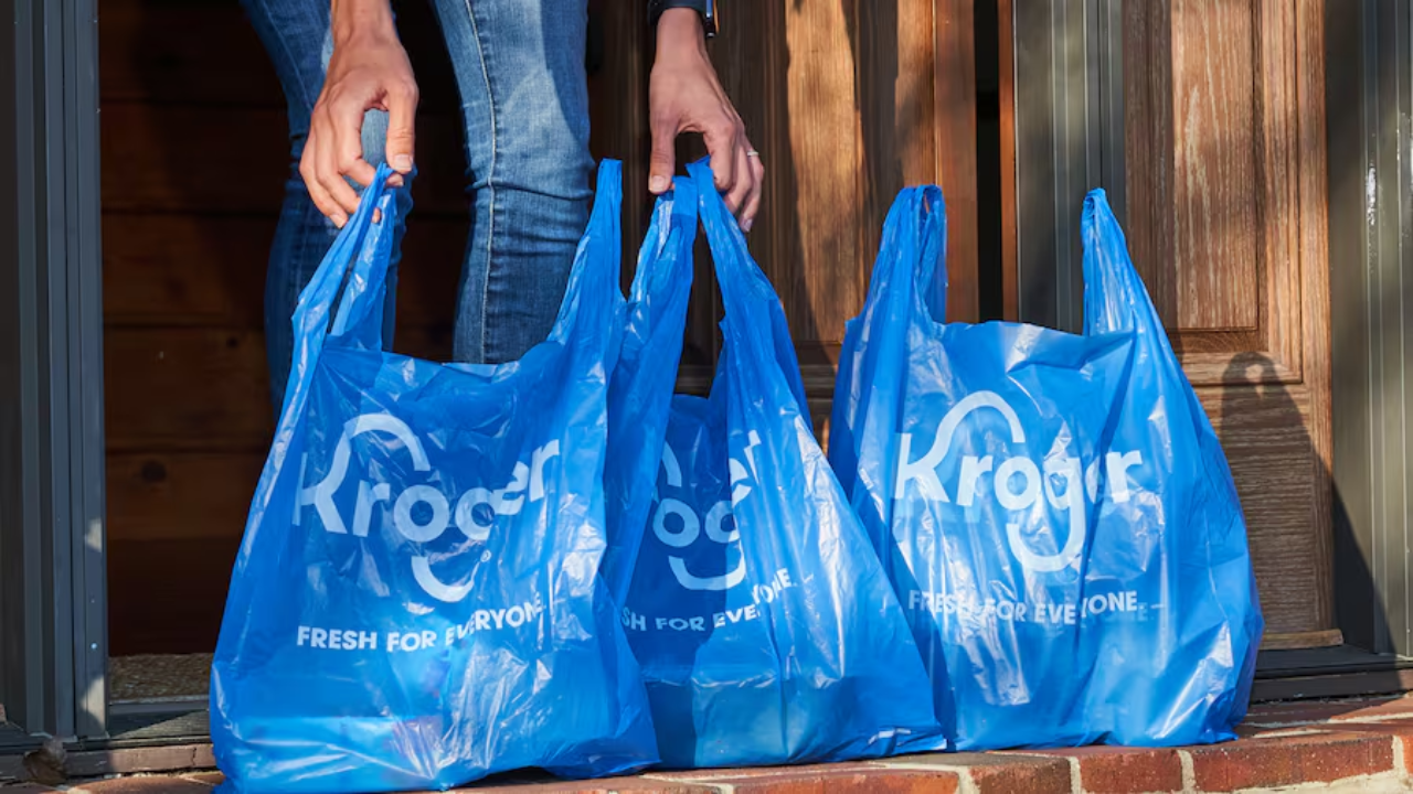 A customer receiving a grocery delivery from Kroger’s automated fulfillment center in Florida."