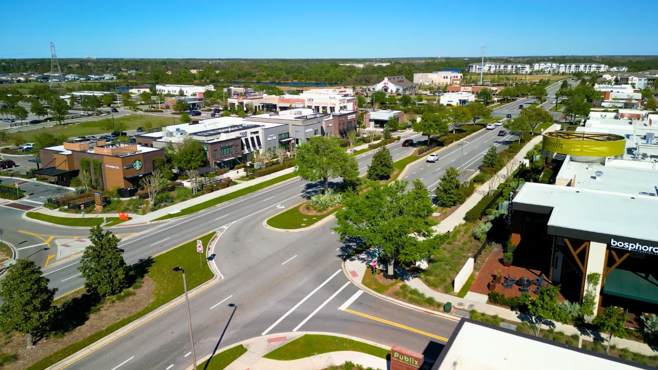 Aerial view of the Hamlin Town Center shops and restaurants along a tree-lined boulevard in Horizon West, Winter Garden, Florida
