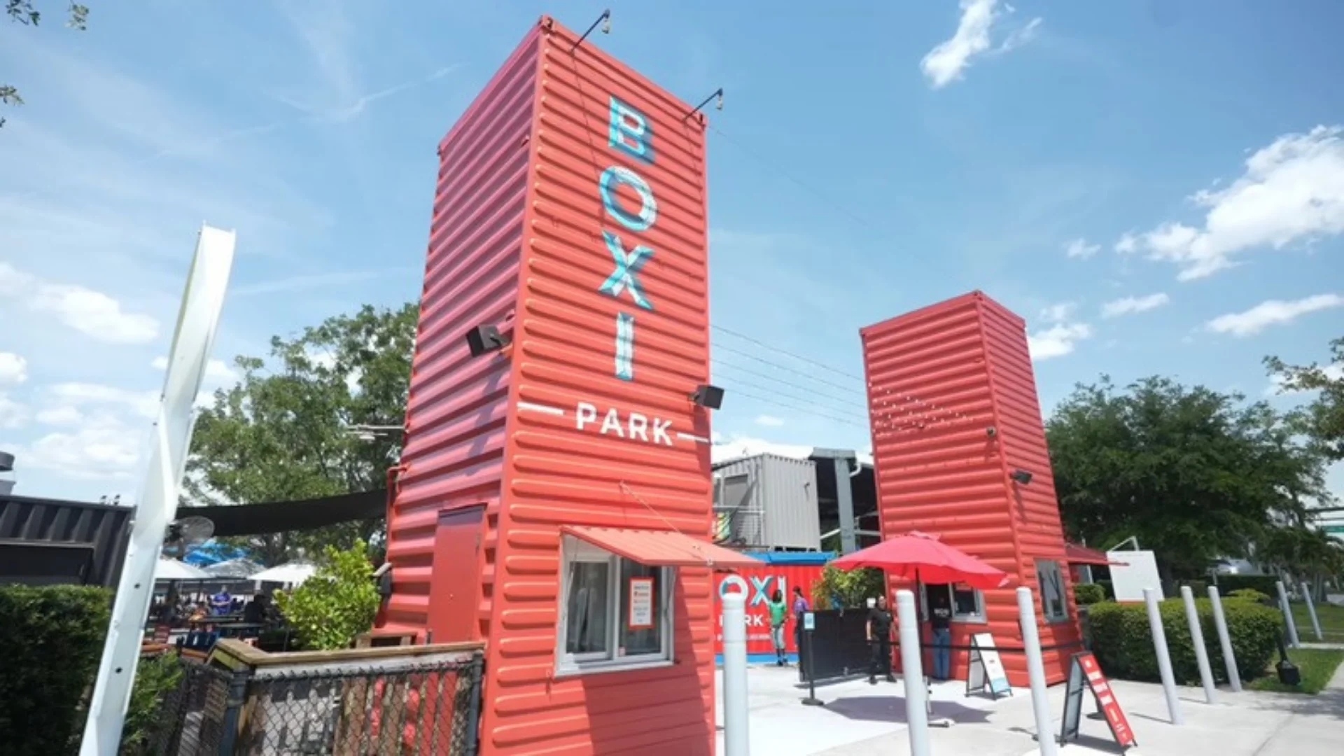 Red shipping container towers at the entrance of Boxi Park in Lake Nona