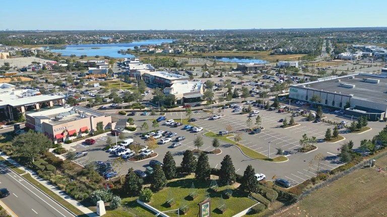 Aerial view of Hamlin Town Center in Horizon West, Winter Garden, Florida, showing Publix, Miller's Ale House and other shops with parking, and lakes and neighborhoods in the distance